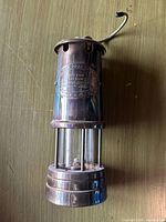 Full view of brass miner’s lamp showing structure