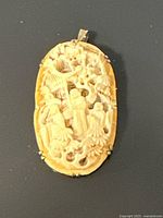 Front view showing carved ivory scene and frame