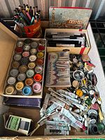 Overview of entire lot showing paints, pens, tin and buttons