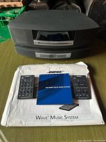 Full system showing Wave Music System on CD changer with remotes and manual