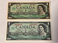 Front view of two 1967 Bank of Canada one-dollar Centennial notes, highlighting serial-numbered and no-serial variants