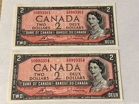 Front view of both 1954 $2 banknotes showing serial numbers, design details, and overall condition