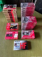 Stacks of sealed Sony HF 90, BASF Ferro Extra I 90, and one Maxell UR 90 two-pack cassette tapes