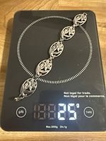 Bracelet on digital scale showing weight