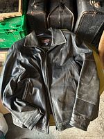 Front view of Danier black leather jacket laid flat