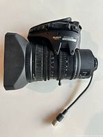 Left side view showing full lens, hood, servo grip and cable