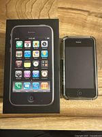 Phone with original box on wooden surface