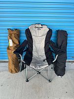 Full view of KingCamp chair open with two folded chairs beside it