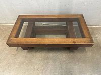 Top view of rectangular wood coffee table with central glass insert