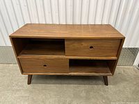 Front view showing overall design with sliding doors and open shelves