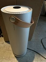 Full view of Molekule Air purifier standing upright with power cord