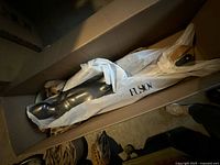 Mannequin body wrapped in tissue inside shipping box