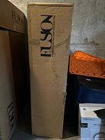 Fusion-branded sealed cardboard box containing mannequin