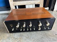 Front angled view of Sansui AU-555A amplifier showing wood case and controls