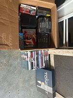 Open box showing multiple sealed Dallas sets, other sealed titles and large Tonight Show box set