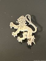 Front view of sterling lion rampant pin