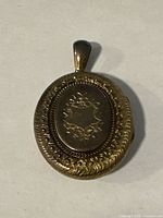 Back view showing engraved wreath motif and bail