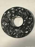 Front view showing openwork scroll pattern and center cut-out