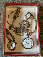 Overview of four watches in box