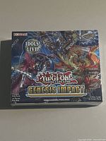 Front of sealed Genesis Impact booster box showing artwork, pack and card details