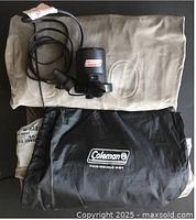 Mattress folded with pump and storage bag visible