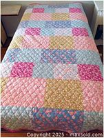 Comforter spread on twin bed showing patchwork pattern