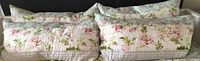 Four floral quilted pillow shams arranged side by side