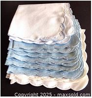 Stack of blue and white scalloped linen napkins