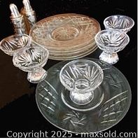Group of crystal egg cups and plates showing pattern