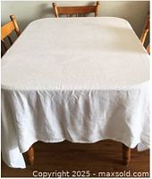 Tablecloth spread on dining table showing size and drape