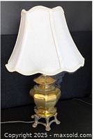 Full view of brass table lamp with white shade
