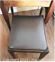 Top view of stool showing brown vinyl seat and scuff