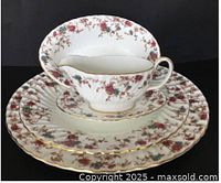 gravy boat on saucer with two platters