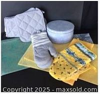 Group shot showing grey quilted mitts & potholders, striped mitt, Marat Avignon mitt & potholder, placemats, tea towel, fabric, cookie tin