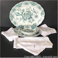 Front view of Ridgway platter, plates, bowls with white embroidered napkins