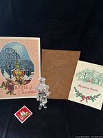 Front covers of two carol booklets, 1948 Regal's program, acrylic drummer ornament, small square Christmas image