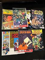 Group shot of all nine comic books laid flat