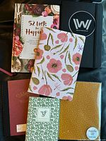 Group shot of all six journals and notebooks