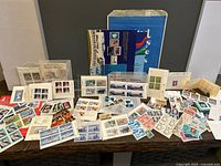 Full lot overview showing folders, keepsake box, sheets, blocks and singles spread on table