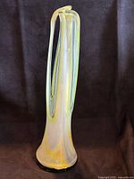 Full view of tall hand-blown art glass sculpture showing overall shape and color