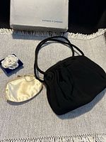 Handbag closed with coin purse, matchbook cover and Eaton’s box in view