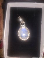 Front view of moonstone pendant in box