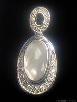Front view of pendant showing mother-of-pearl center and CZ halo