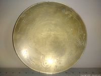Front view of engraved brass bowl showing full design