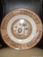Front view of ironstone plate showing lion scene and border