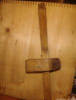 Full view of wooden marking gauge on wooden background