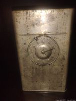 Front view showing clock dial and patina