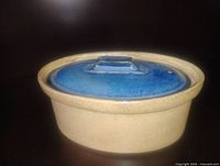 Stoneware oval dish with blue lid, side view