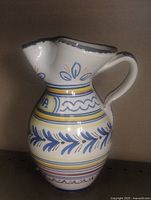 Front view of glazed pottery pitcher jug