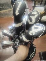 Top view showing woods with headcovers and irons